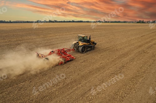Preview: Crawler tractor harrowing and leveling soil for next seeding in rural plain fields