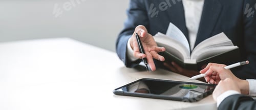 Preview: Business partnership using tablet to analysis graph company financial budget report in office room.