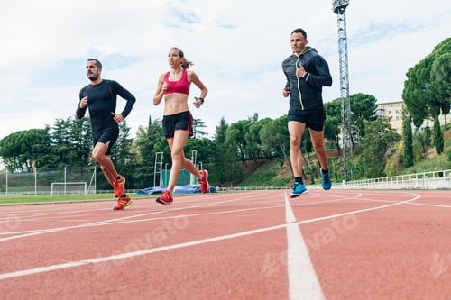 Preview: Group of young people running on the track field
