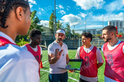 Preview: Coach discussing soccer strategy with diverse team players