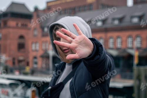 Preview: Female hand with rings on a blurred background.
