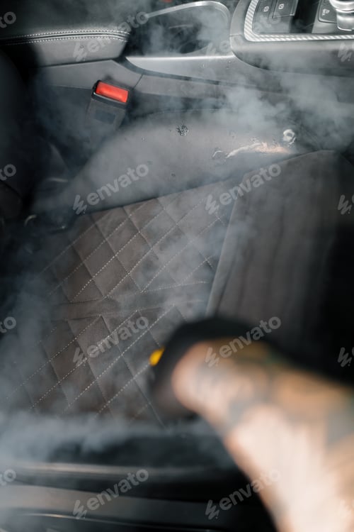 Preview: The detailing master cleans the car interior with a hot steam cleaner Cleaning the car interior