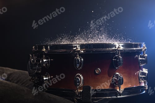 Preview: Close-up, snare drum on dark background with stage spotlight.