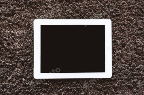 Preview: Tablet mockup lying on the floor on the carpet. Indoors in the center