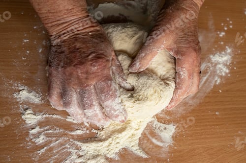Preview: Hands of the grandmother prepare homemade dough.