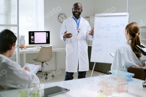 Preview: Middle Aged Black Man Explaining Chemical Formulas to Young Adult Scientists