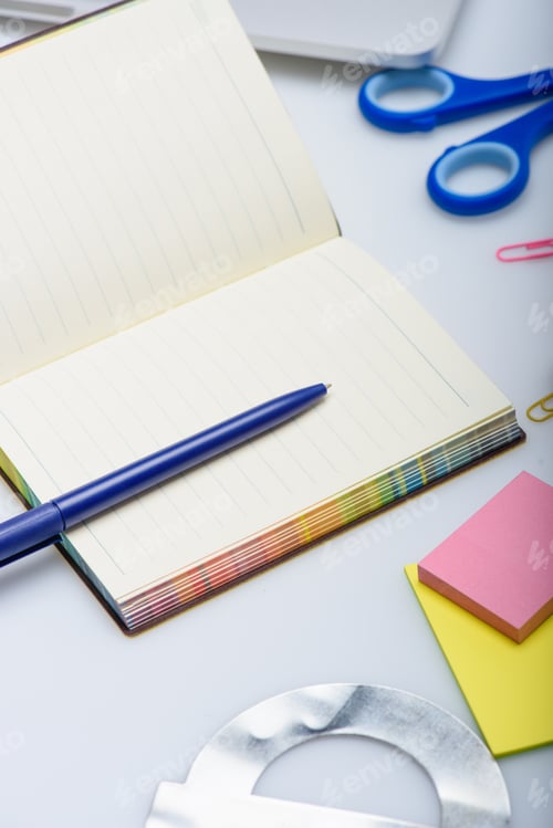Preview: empty copybook and different school supplies isolated on white