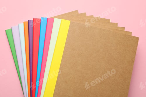 Preview: Different copybooks on pink background, flat lay