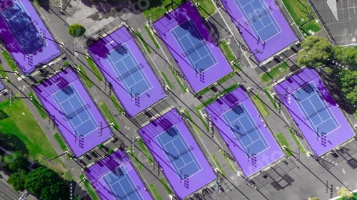 Preview: Aerial view of purple tennis courts in a park.