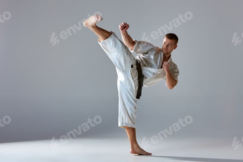 Preview: Man in white kimono training karate