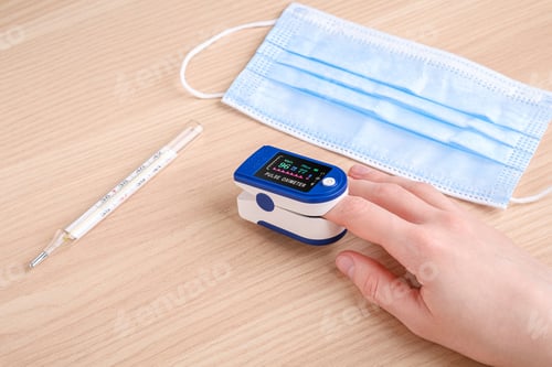 Preview: Person using pulse oximeter device near to thermometer and medical mask