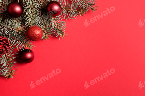 Preview: Christmas frame with fir branches, red balls on red background.