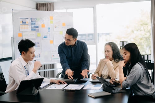 Preview: Furious two Asian businesspeople arguing strongly after making a mistake at work in office