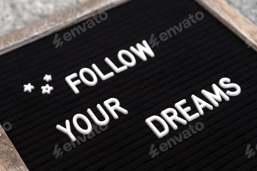 Preview: Letter board sign "Follow your dreams” in a wooden frame. Closeup view.
