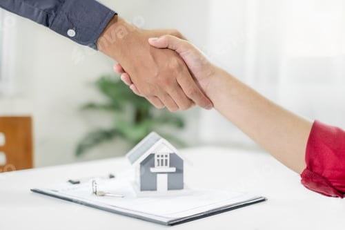 Preview: Businessmen and brokers real estate agents shake hands after completing negotiations to buy house