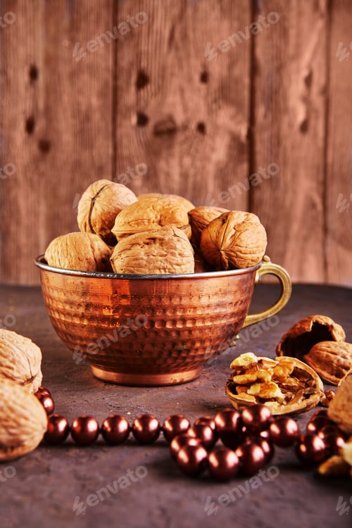 Preview: Walnuts in a tin cup, whole and finely chopped, next to the filling and shell.