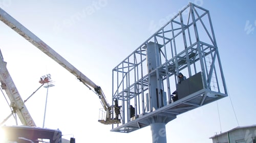 Preview: Builder on a Lift Platform at a construction site. Men at work. construction worker assembling