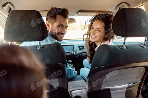 Preview: Back view of happy family riding car, mother and father turning back to daughter, enjoying road trip