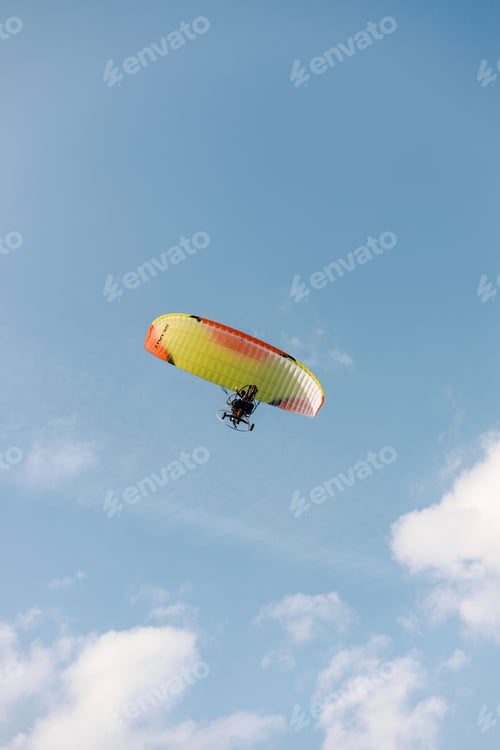 Preview: A person paragliding in a sky on a clear day