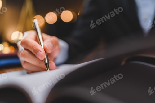 Preview: businessman or legal expert reviewing document reports at office workplace with computer laptop