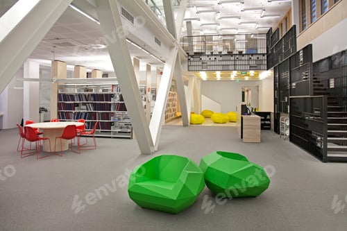 Preview: A healthcare college library with open spaces, green chairs and book stacks