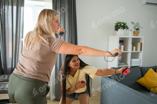 Preview: Cheerful group of friends playing video games together at home, leisure and entertainment concept