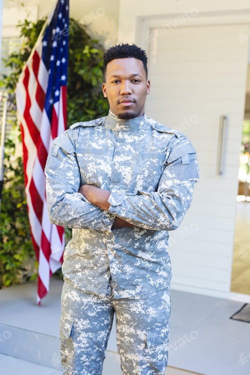 Preview: African american male soldier standing with arms crossed outside home with usa flag, copy space