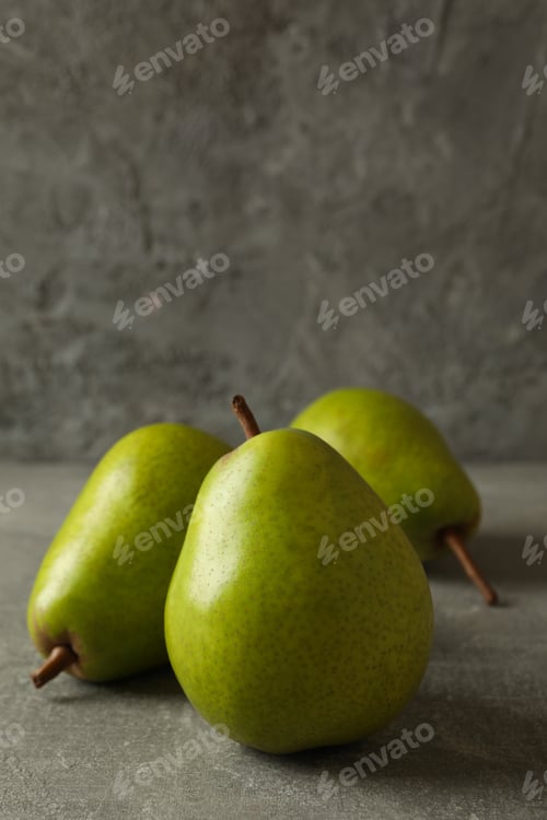 Preview: Fresh green pears on gray background, space for text