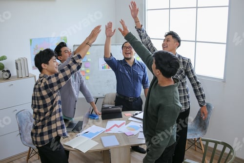 Preview: Five Smiling Men Celebrating Success With Hands Raised In Unison