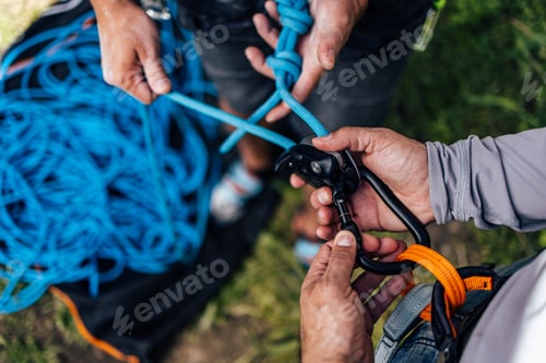 Preview: Close-Up of Hands Preparing Gear for a Rock Climbing Adventure