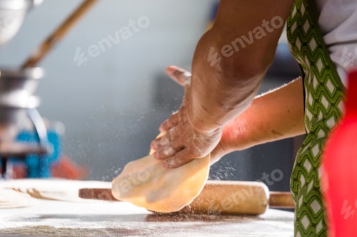 Preview: Closeup shot of a kneading dough while making Chapatti bread