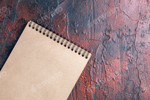 Preview: top close view a notebook on dark red background free place