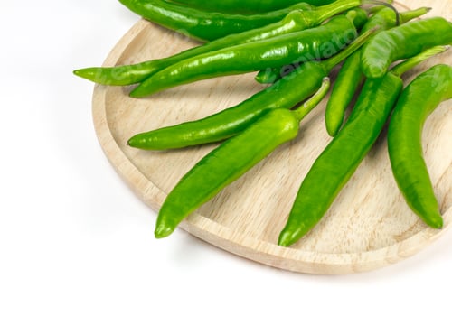 Preview: Green chili pepper on the wooden plate, isolated on the white background
