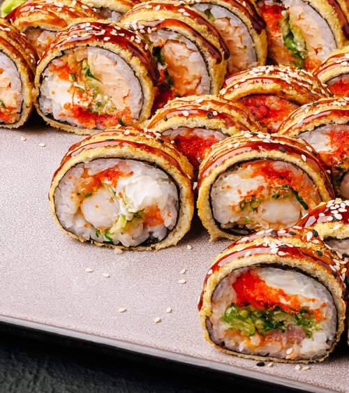 Preview: Sushi rolls arranged elegantly on a platter with vibrant colors and textures