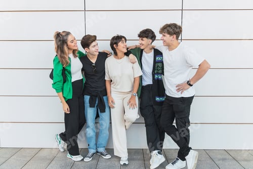 Preview: Group of diverse friends on street holding one another