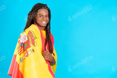 Preview: Latin man with dreadlocks wrapping with a spanish national flag