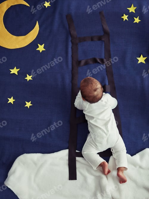 Preview: Concept shot of an adorable baby boy climbing a ladder against an imaginary night time background