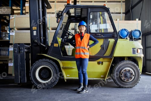Preview: Portrait of confident female worker at forklift in factory
