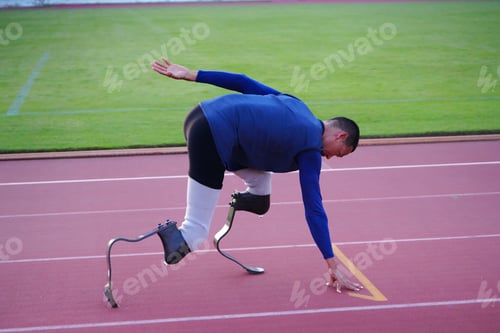 Preview: Asian para-athletes with prosthetic blades sprint on a running track at stadium.