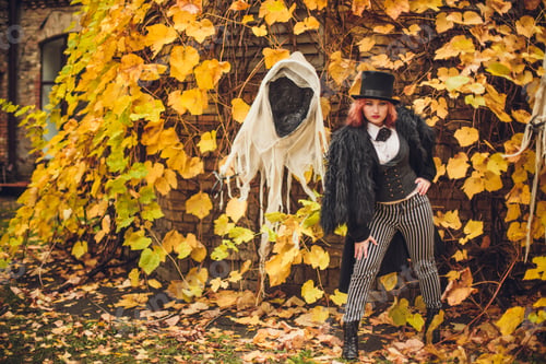 Preview: woman dressed for Halloween party in witch costume and a ghost
