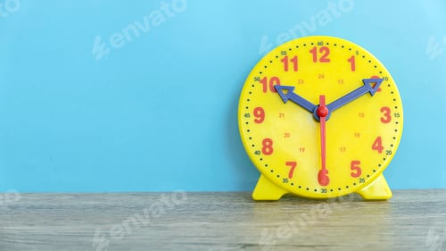 Preview: Yellow clock against a blue background with copy space.