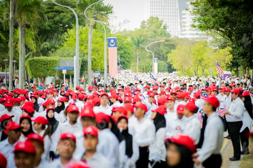 Preview: merdeka malaysia independence day celebration with crowds of people wearing red cap
