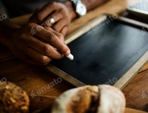 Preview: Closeup of hand writing on black chalkboard