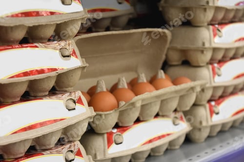 Preview: cardboard box with eggs on a shelf in a supermarket. shopping for the upcoming Easter.
