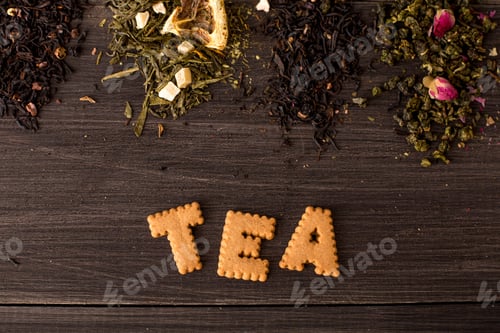 Preview: Several views of tea and a cookie inscription on a wooden background