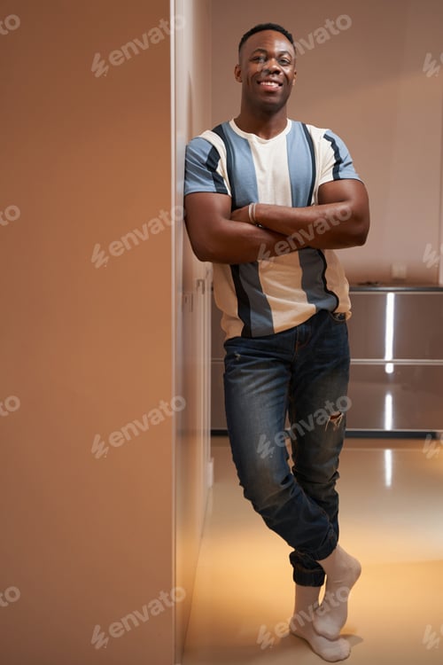 Preview: Strong multiracial American with crossed arms smiling to camera