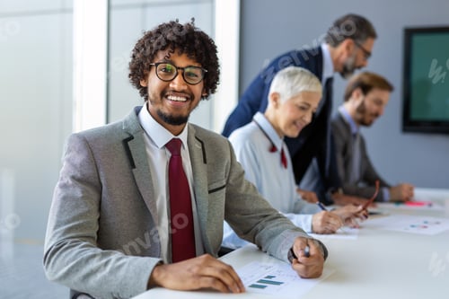 Preview: Group of coworkers working together on business project in modern office