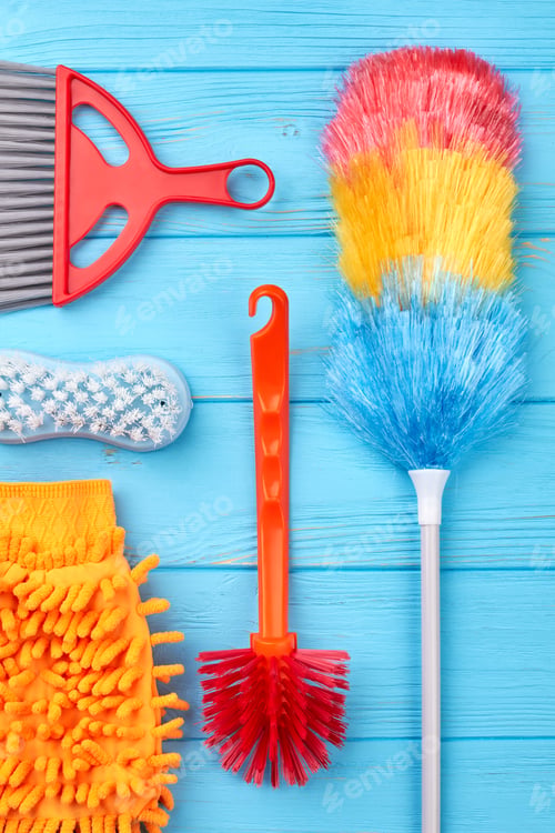 Preview: Cleaning equipment on blue wooden background.