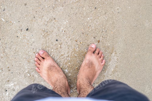 Preview: Male barefoot on the beach with suntanned shape of sandals