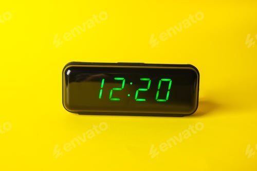 Preview: Digital alarm clock showing 12:20 o'clock on yellow background